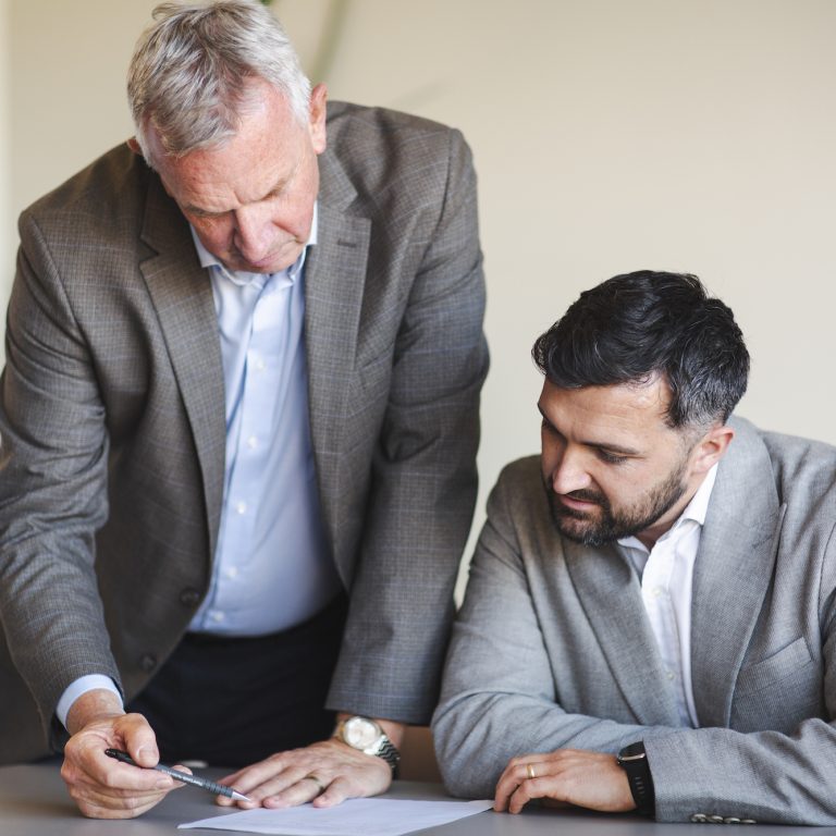 Two professionals goin through Procurement Contract Risks