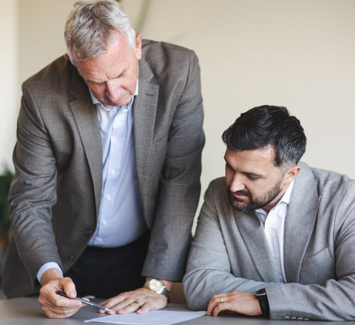 Two professionals goin through Procurement Contract Risks