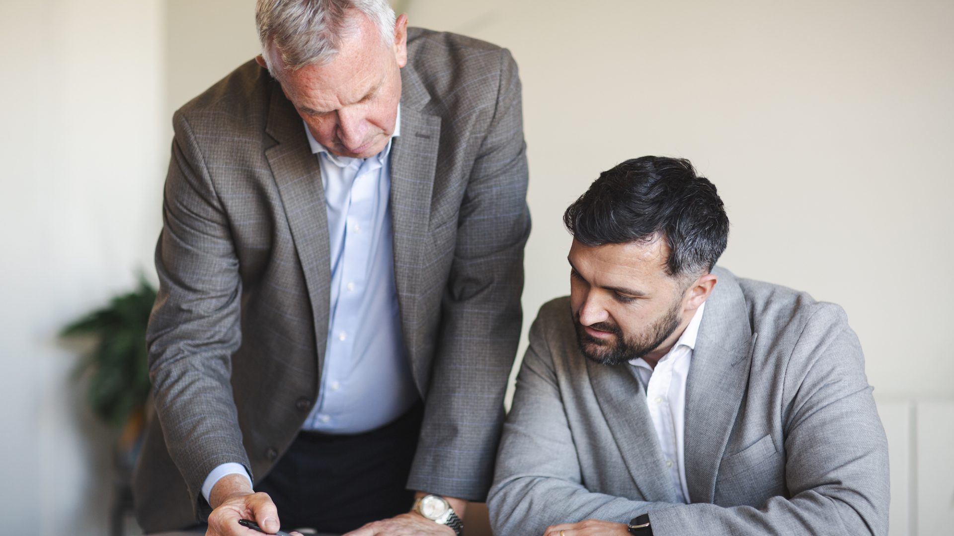 Two professionals goin through Procurement Contract Risks
