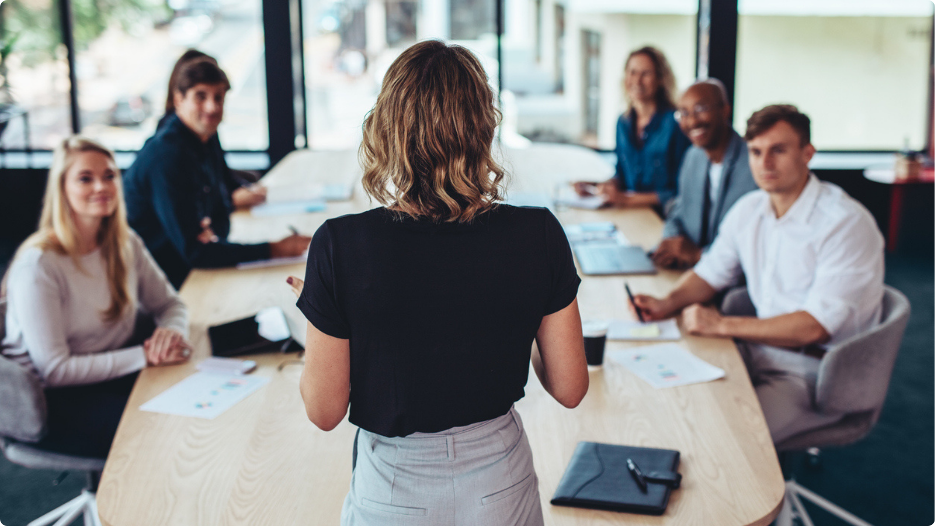 Management Training in practice with a manager directing their team in a boardroom
